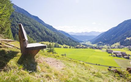 Panoramic view over the green Gsies Valley and the surrounding mountains.