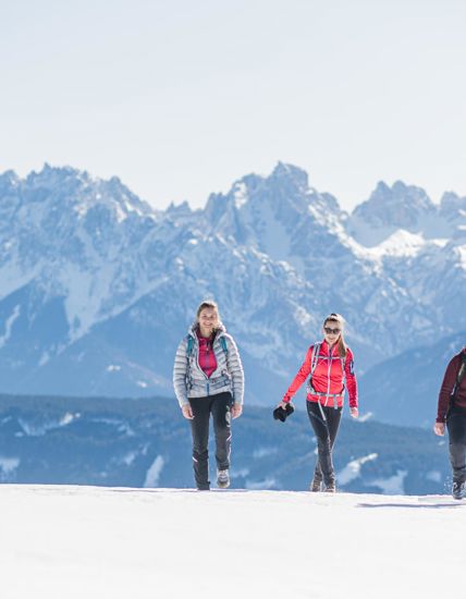 Three women on a winter hike in the Dolomites