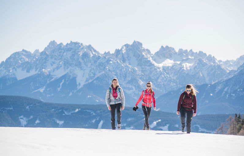 Three women on a winter hike in the Dolomites